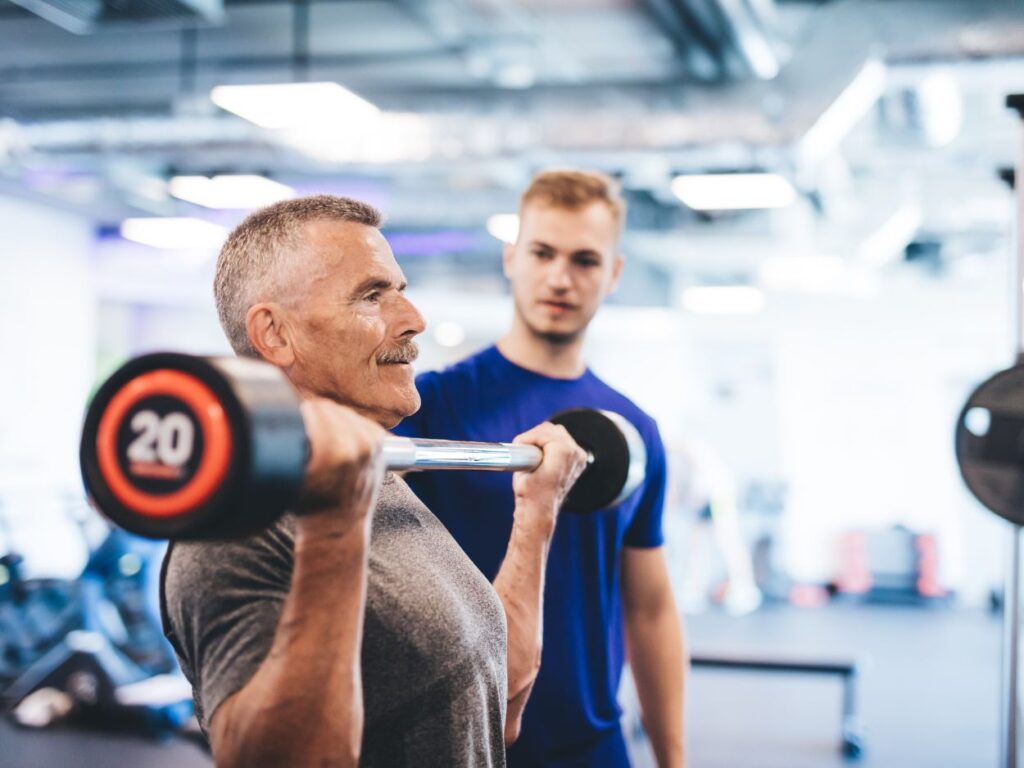 an older man lifting weights